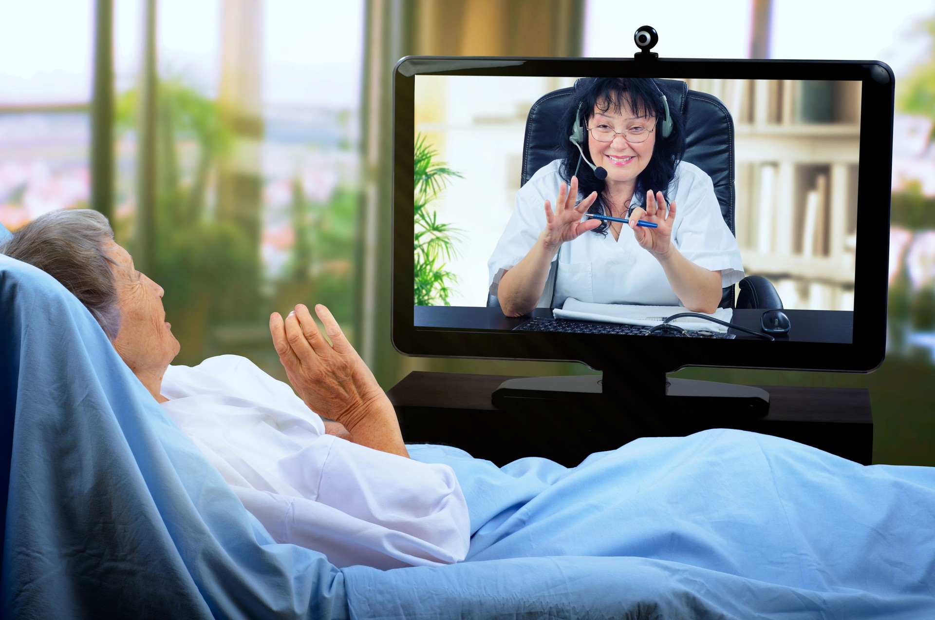 A gerontologist communicates in real time with a quarantine elderly patient.