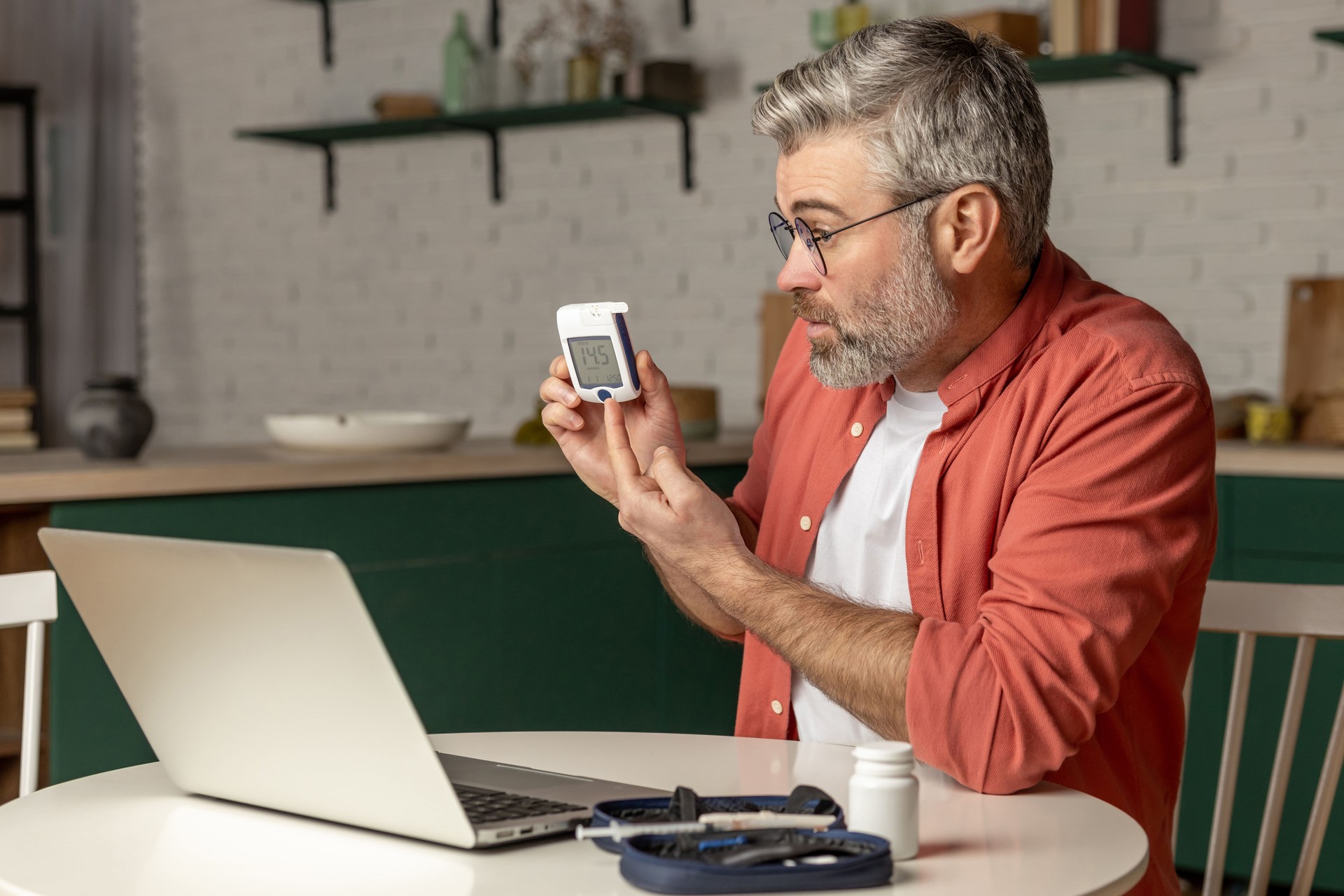 Online medical consultation for diabetic patient man with glucometer via laptop